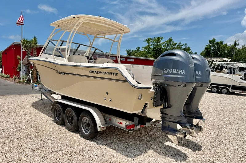 Slide: The Image of 2015 Grady-White Freedom 275 boat with dual Yamaha engines on a trailer. - 7