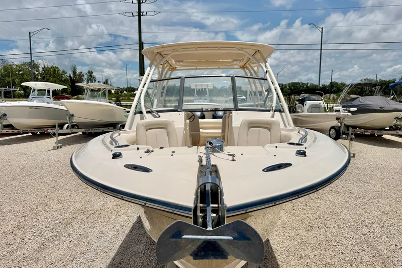 Slide: The Image of 2015 Grady-White Freedom 275 boat displayed outdoors under a partly cloudy sky. - 8