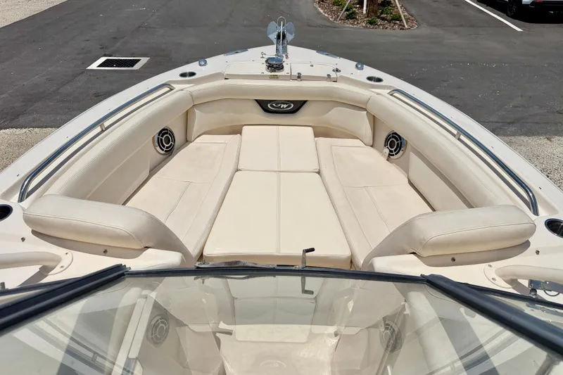 Slide: The Image of 2015 Grady-White Freedom 275 boat interior with beige seating and speakers. - 9