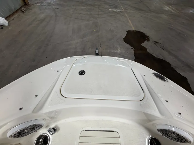 Slide: The Image of Rear view of a 2012 Sea Ray 220 Sundeck boat in a warehouse. - 31