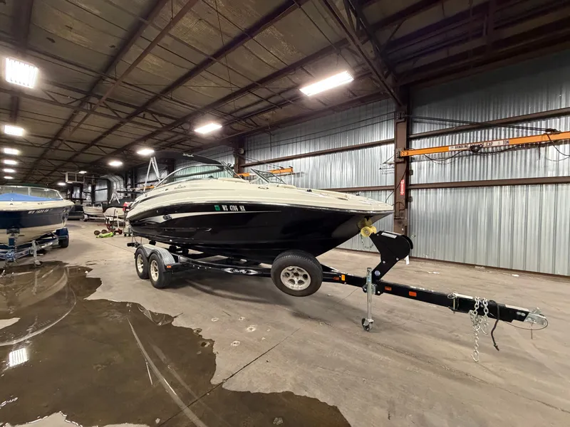 Slide: The Image of 2012 Sea Ray 220 Sundeck on trailer in warehouse. - 49
