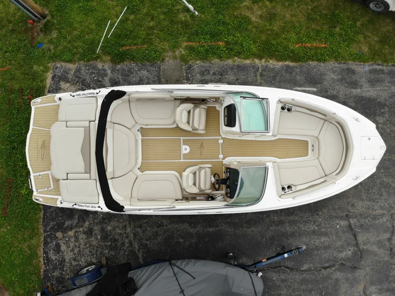 The Image of Aerial view of a 2011 Chaparral 246 SSi boat on asphalt. - 0