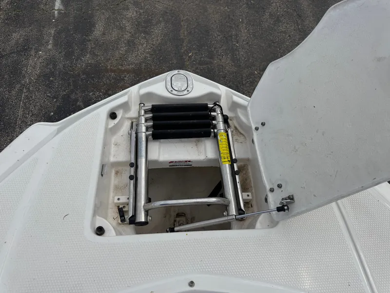 Slide: The Image of Open storage hatch of a 2011 Chaparral 246 SSi boat. - 11