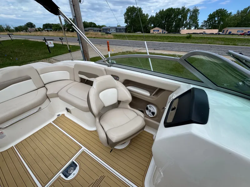 Slide: The Image of Interior of a 2011 Chaparral 246 SSi boat with beige seating. - 13