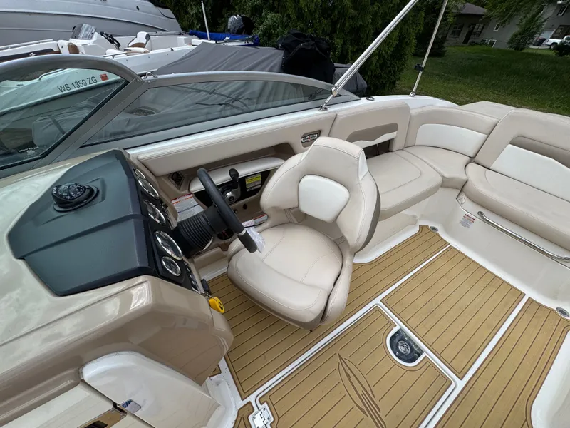 Slide: The Image of Interior of a 2011 Chaparral 246 SSi boat with beige seating. - 14