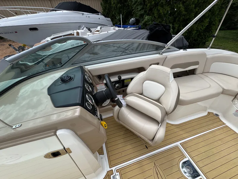 Slide: The Image of Interior of a 2011 Chaparral 246 SSi boat with steering wheel and seating. - 15