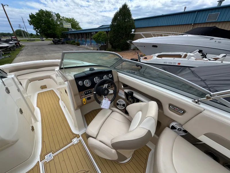 Slide: The Image of Interior of a 2011 Chaparral 246 SSi boat with steering console. - 16