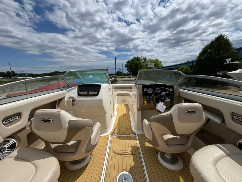 Slide: The Image of Interior of a 2011 Chaparral 246 SSi boat with two seats and steering. - 24