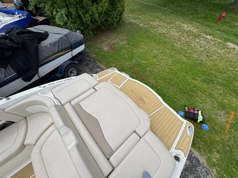 Slide: The Image of Chaparral 246 SSi 2011 boat with cushioned deck and grass in background. - 29