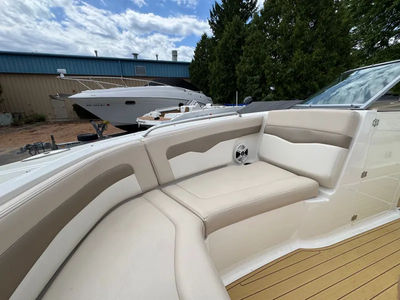 Slide: The Image of Interior of a 2011 Chaparral 246 SSi boat with beige seating. - 8