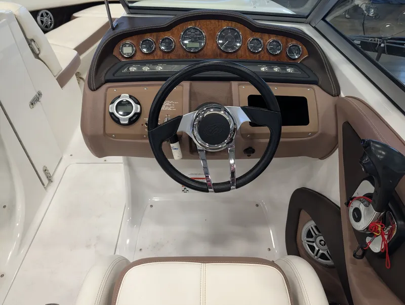 Slide: The Image of Interior view of a 2011 Cobalt 242 boat cockpit with steering wheel and gauges. - 10