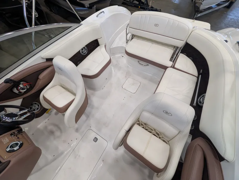 Slide: The Image of Interior of a 2011 Cobalt 242 boat with white leather seating. - 11