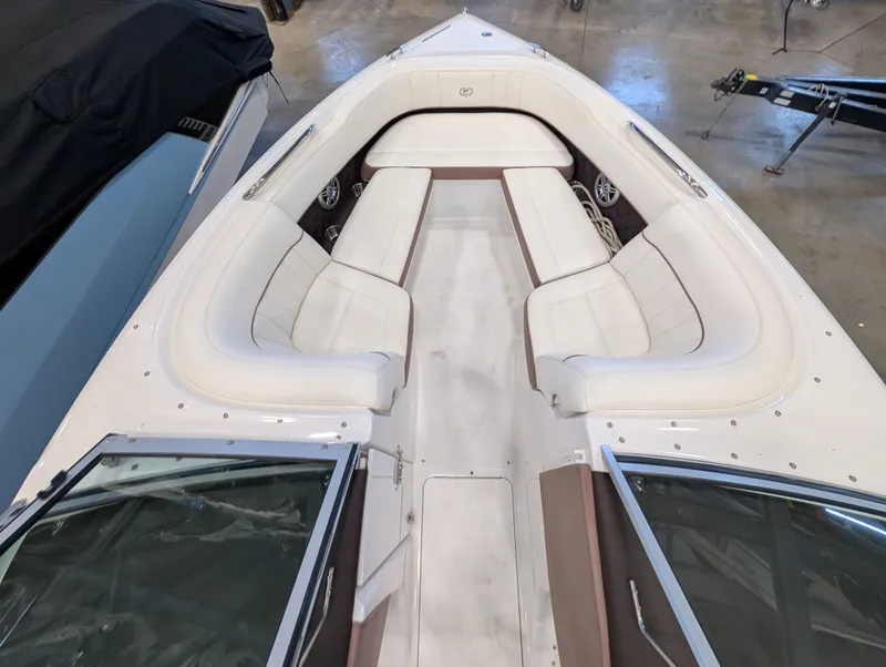 Slide: The Image of Interior view of a 2011 Cobalt 242 boat with white seating. - 12