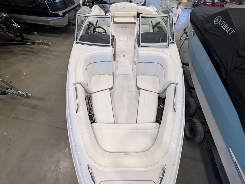 Slide: The Image of Interior view of a 2011 Cobalt 242 boat with white seating. - 13