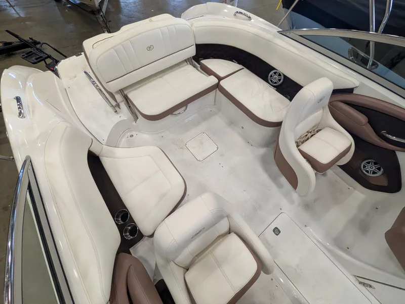 Slide: The Image of Interior of a 2011 Cobalt 242 boat with white and brown seating. - 15