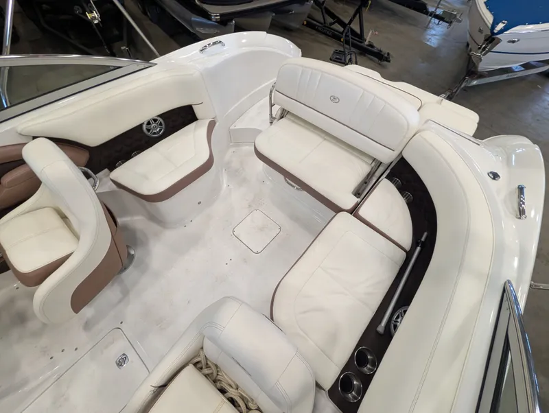 Slide: The Image of Interior of a 2011 Cobalt 242 boat with white leather seating. - 16
