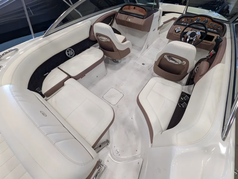 Slide: The Image of Interior of a 2011 Cobalt 242 boat with white and brown seating. - 18