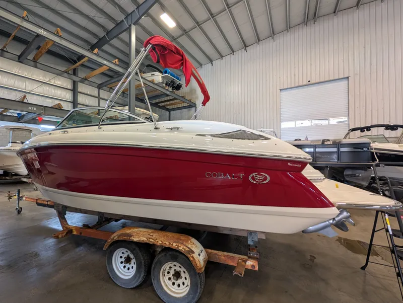 Slide: The Image of Red 2011 Cobalt 242 boat in warehouse on trailer. - 4