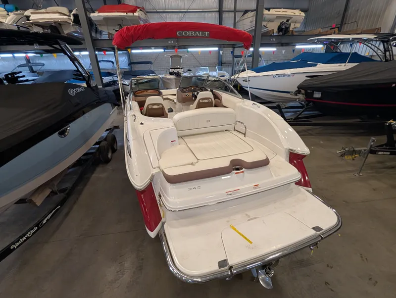Slide: The Image of 2011 Cobalt 242 boat in storage with red canopy. - 5