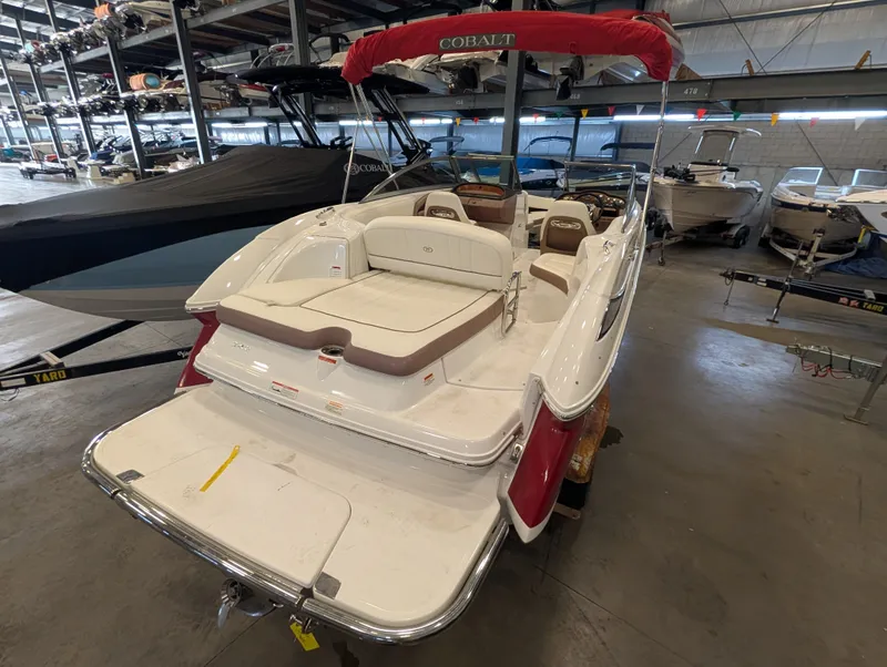 Slide: The Image of 2011 Cobalt 242 boat in warehouse with red sunshade. - 6