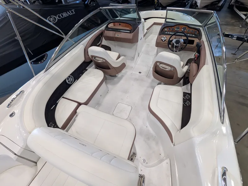 Slide: The Image of Interior of a 2011 Cobalt 242 boat with white and brown seating. - 9