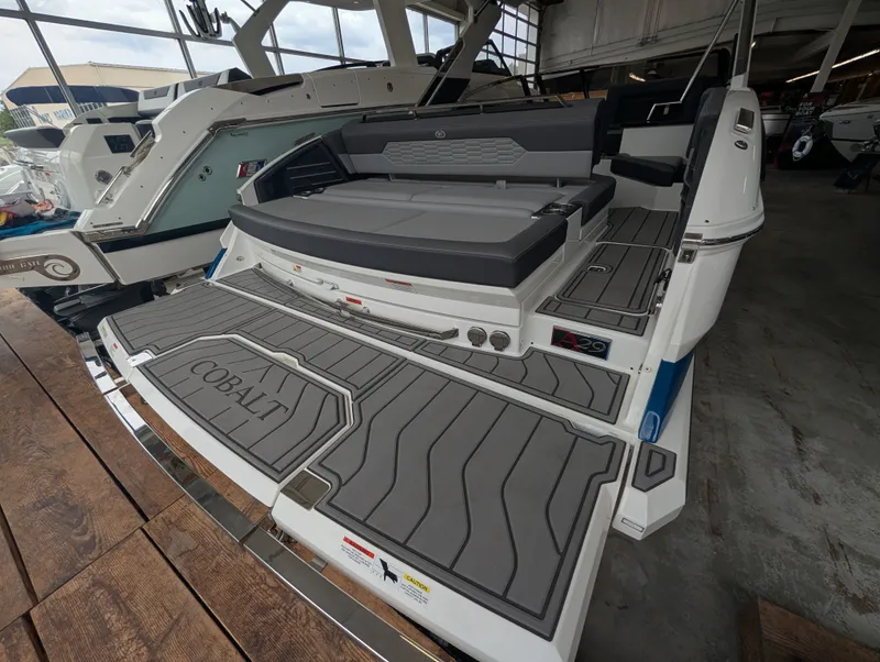 Slide: The Image of 2026 Cobalt A29 boat with luxurious deck design in a showroom. - 14