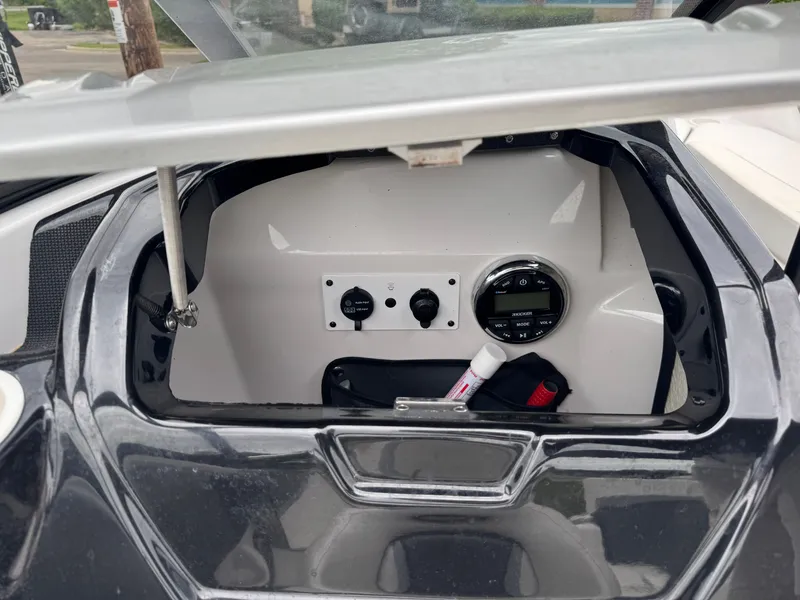Slide: The Image of 2017 Scarab SB 195 JET boat control panel with open compartment. - 13
