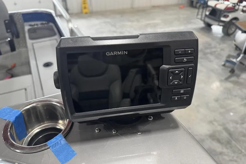 Slide: The Image of Garmin device on 2018 Lowe SF 214 Sport Fish boat dashboard in a garage setting. - 11