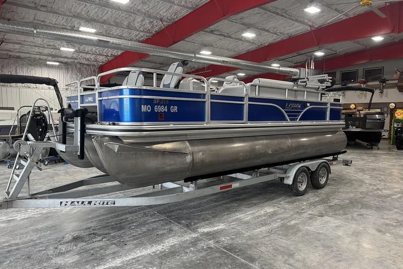 Slide: The Image of 2018 Lowe SF 214 Sport Fish pontoon boat on trailer in indoor showroom. - 3