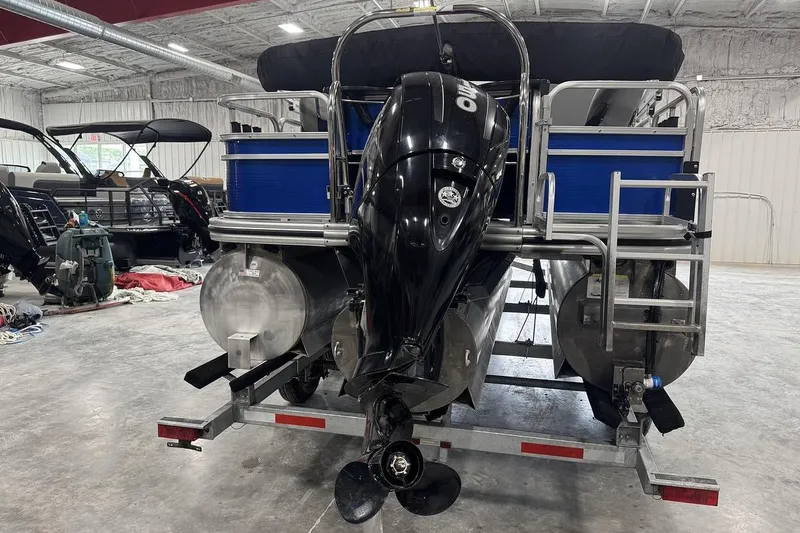 Slide: The Image of 2018 Lowe SF 214 Sport Fish pontoon boat with outboard motor in a storage facility. - 5