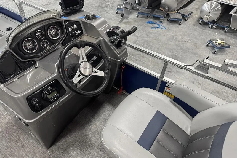 Slide: The Image of 2018 Lowe SF 214 Sport Fish boat dashboard with steering wheel and gauges. - 9
