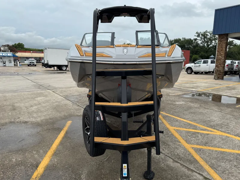 Slide: The Image of 2026 Supra SL 450 boat on trailer parked outdoors. - 7