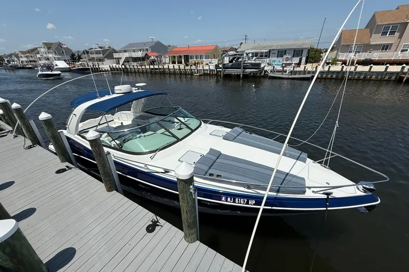 The Image of 2012 Formula 350 Sun Sport docked at a marina, surrounded by waterfront homes. - 0