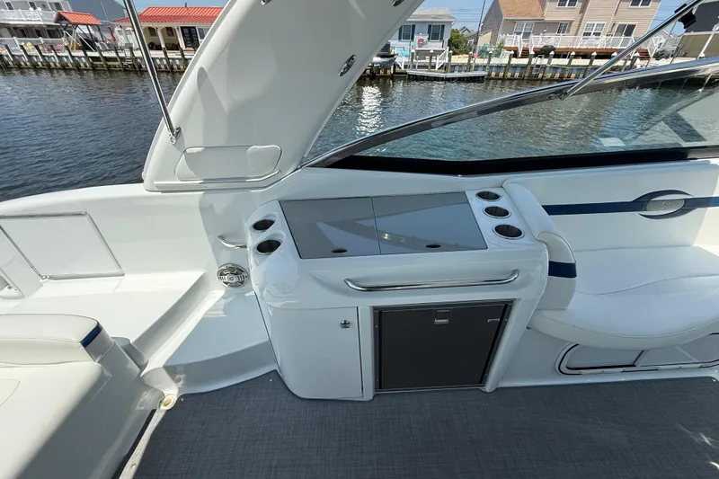 Slide: The Image of 2012 Formula 350 Sun Sport boat interior with seating and storage, dockside view. - 11