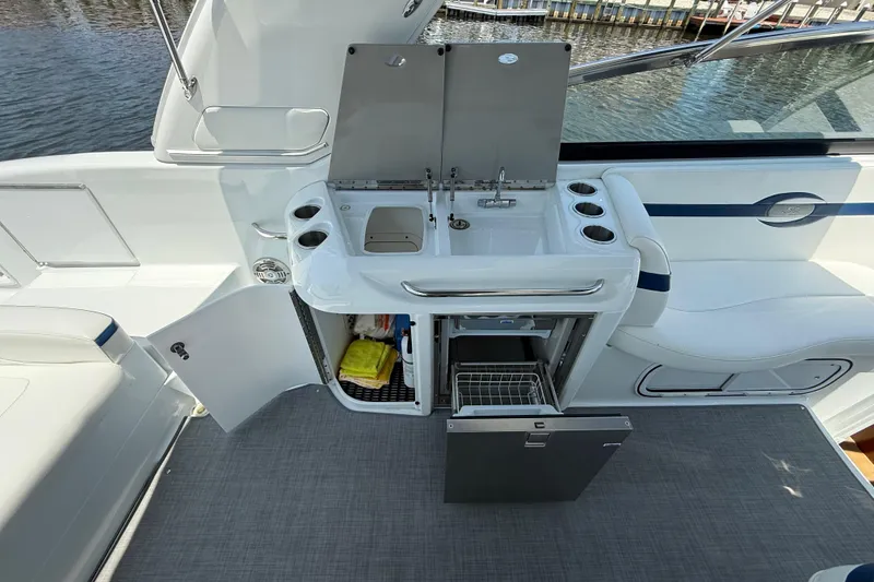 Slide: The Image of 2012 Formula 350 Sun Sport boat interior with kitchenette and seating area. - 12
