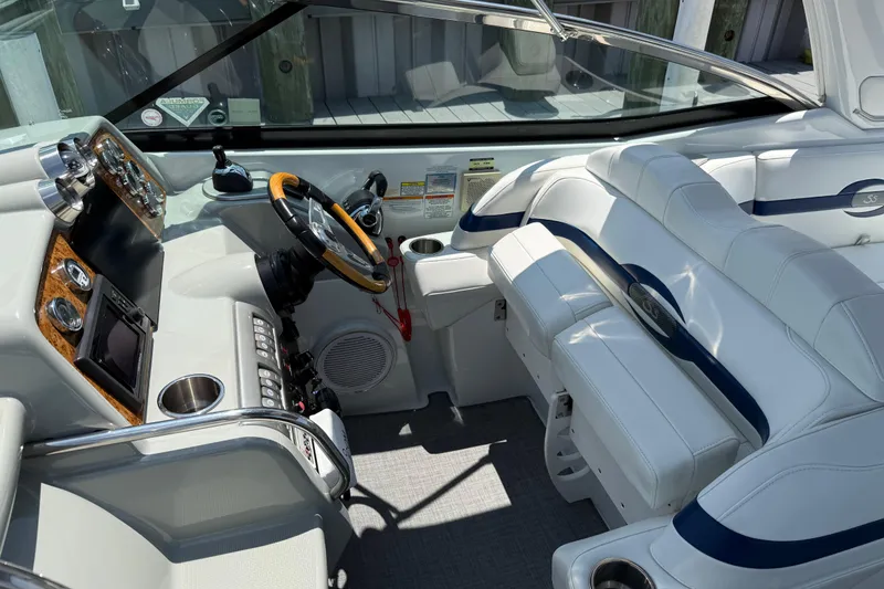 Slide: The Image of Interior of a 2012 Formula 350 Sun Sport boat with white seating and control panel. - 13
