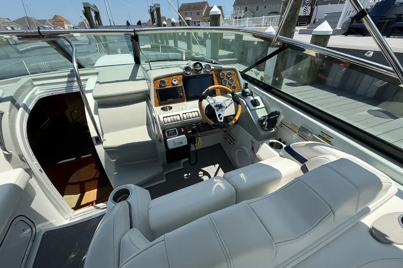 Slide: The Image of 2012 Formula 350 Sun Sport boat cockpit with modern controls and plush seating. - 14