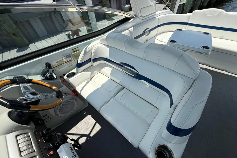 Slide: The Image of Interior of a 2012 Formula 350 Sun Sport boat with white seating and wooden steering wheel. - 16