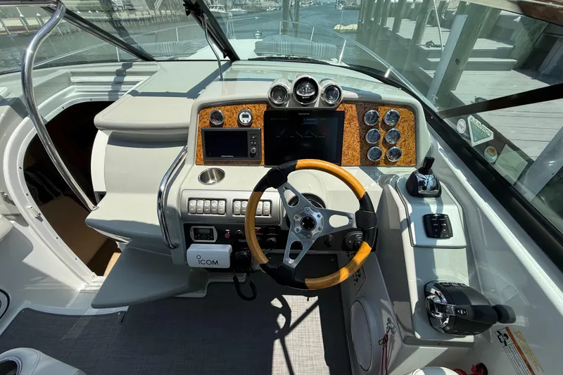 Slide: The Image of Cockpit of 2012 Formula 350 Sun Sport boat with modern controls and wooden steering wheel. - 17