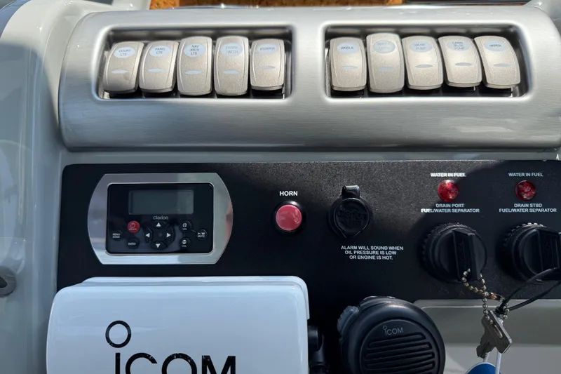 Slide: The Image of Control panel of a 2012 Formula 350 Sun Sport boat with switches and Icom radio. - 23