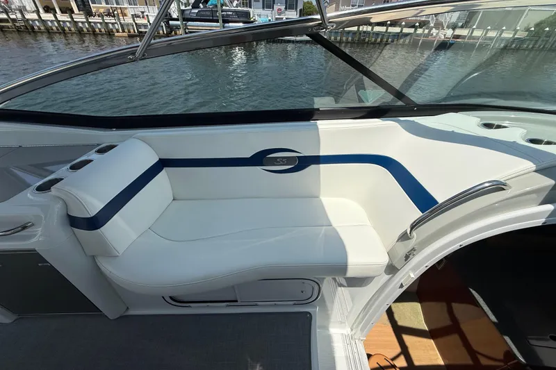 Slide: The Image of 2012 Formula 350 Sun Sport boat interior with white and blue seating by the water. - 26