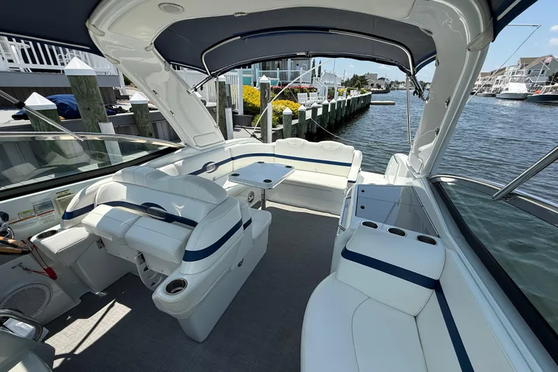 Slide: The Image of 2012 Formula 350 Sun Sport boat interior with white seating and waterfront view. - 28