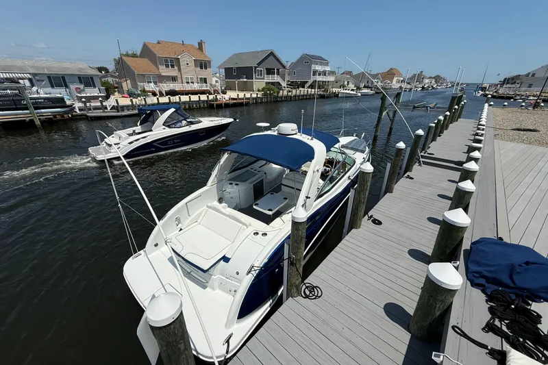 Slide: The Image of 2012 Formula 350 Sun Sport docked at a marina, surrounded by waterfront homes. - 3