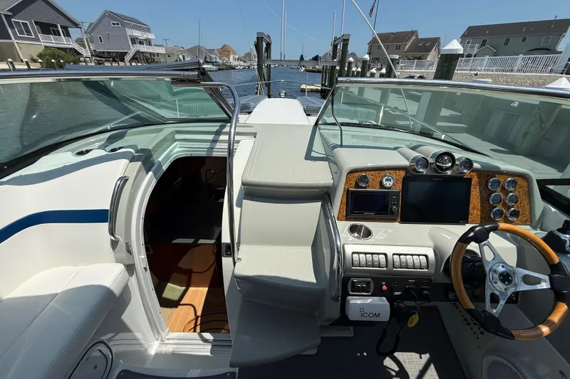 Slide: The Image of 2012 Formula 350 Sun Sport boat interior with helm, dashboard, and waterfront view. - 30