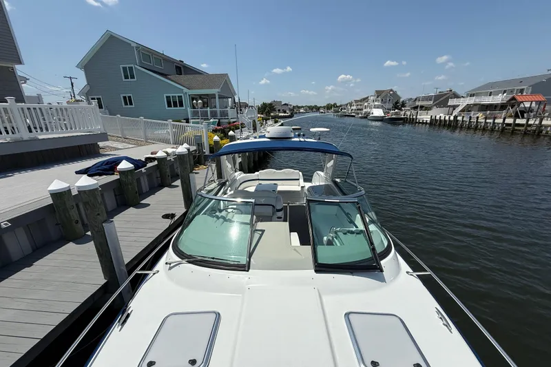 Slide: The Image of 2012 Formula 350 Sun Sport docked by waterfront homes under a clear blue sky. - 34