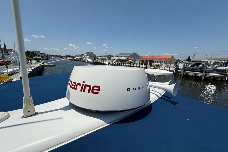 Slide: The Image of 2012 Formula 350 Sun Sport boat docked, featuring marine radar equipment under a clear blue sky. - 35