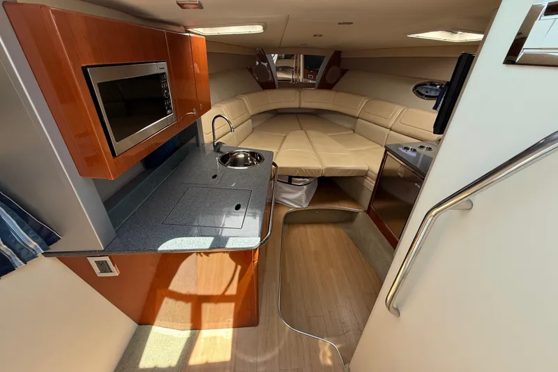 Slide: The Image of Interior of a 2012 Formula 350 Sun Sport boat with kitchenette and seating area. - 36