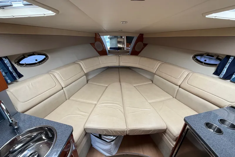 Slide: The Image of Luxurious interior of a 2012 Formula 350 Sun Sport boat with beige seating and portholes. - 38