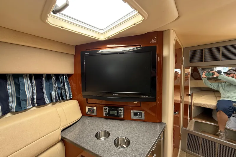 Slide: The Image of Interior of 2012 Formula 350 Sun Sport boat with TV, seating, and porthole. - 39
