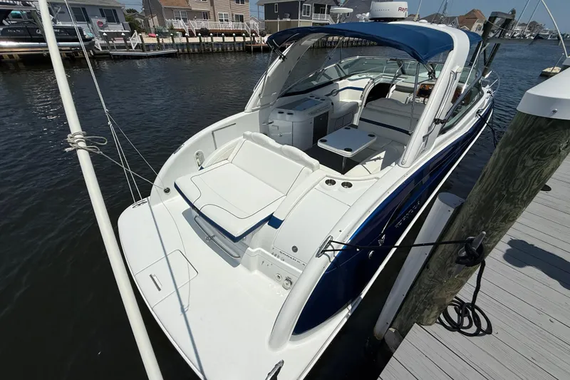 Slide: The Image of 2012 Formula 350 Sun Sport boat docked at marina, featuring sleek design and spacious seating. - 4